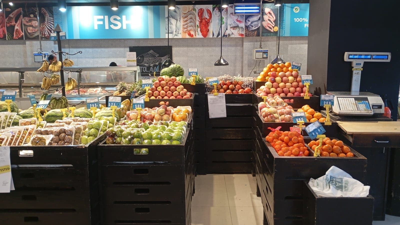 Crates of fresh fruit in front of the Khulshi Mart fish counter